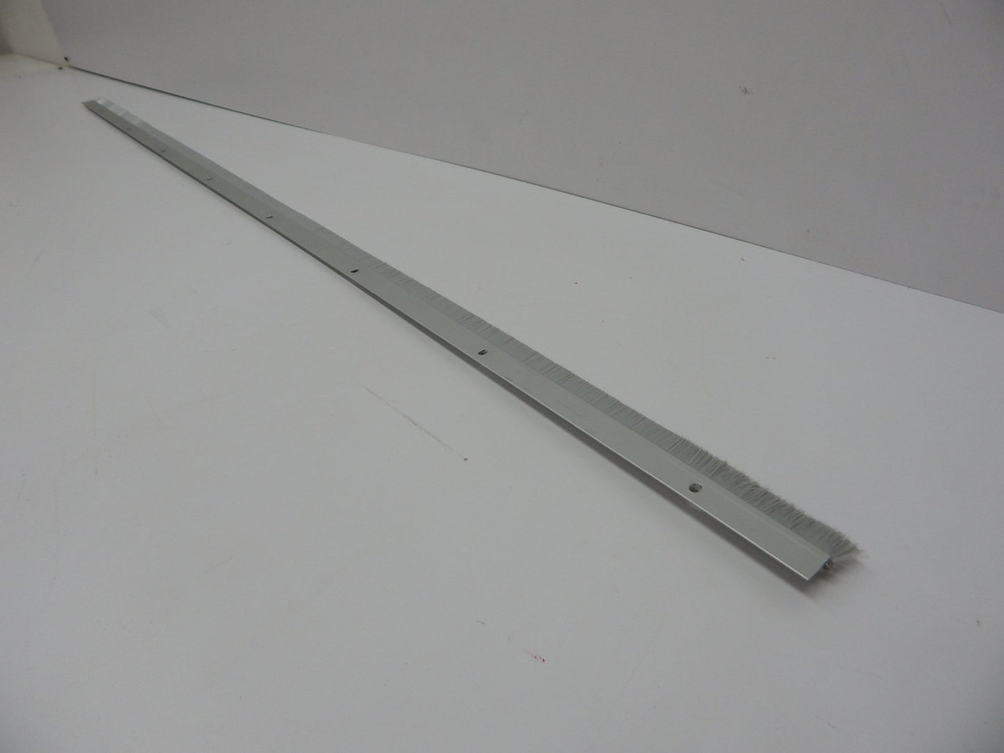 Pemko Brush Door Bottom Sweep, Clear Anodized Aluminum with 0.625" Gray Nylon Brush insert, 0.25" Width, 1.375" H x 48" L - 18061CNB48
