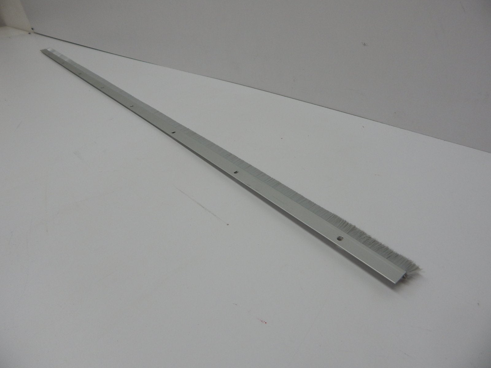 Pemko Brush Door Bottom Sweep, Clear Anodized Aluminum with 0.625" Gray Nylon Brush insert, 0.25" Width, 1.375" H x 48" L - 18061CNB48