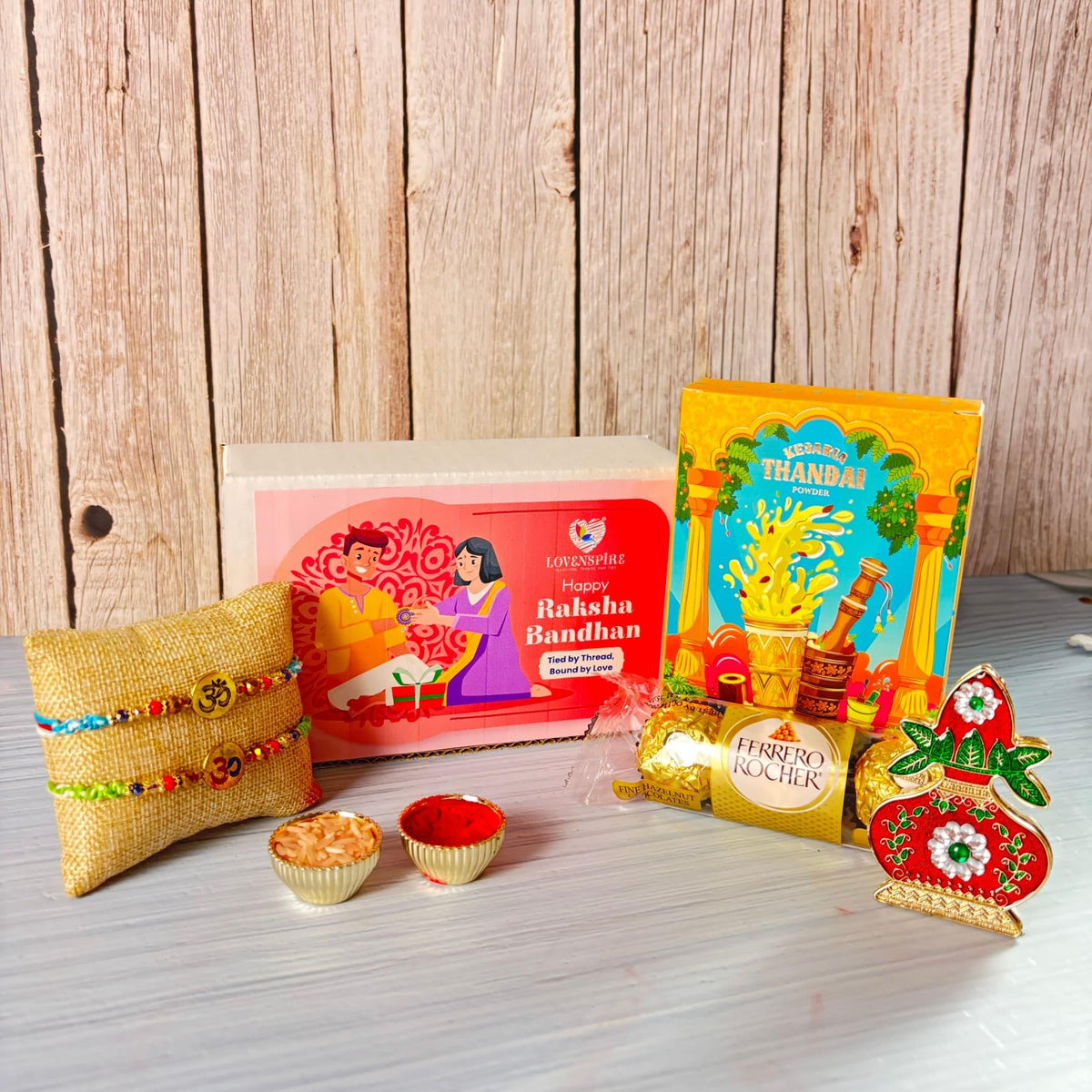 LOVENSPIRE Religious Om Rakhi Hamper for Brother - Includes 2 Colorful Adjustable Bracelet Threads, Chocolate, Haldi Kumkum Holder, Thandai, Roli