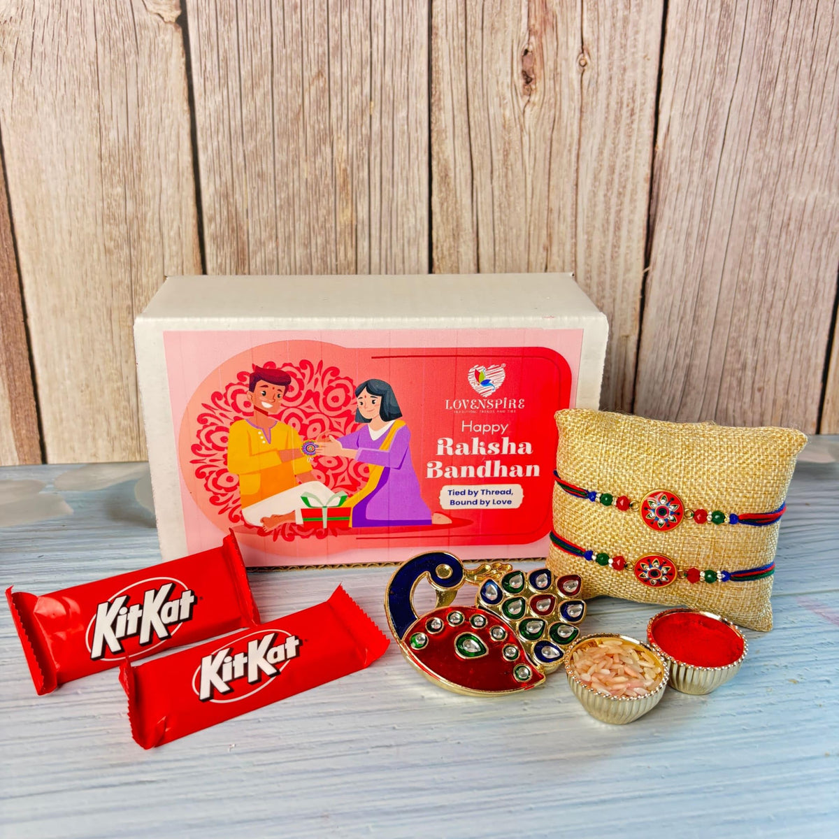 LOVENSPIRE Designer Rakhi Gift Hamper Set for Brother & Bhabhi - Includes 2 Rakhi Bracelet, Haldi Kumkum Holder, Chocolates, Roli Chawal & Gift Box
