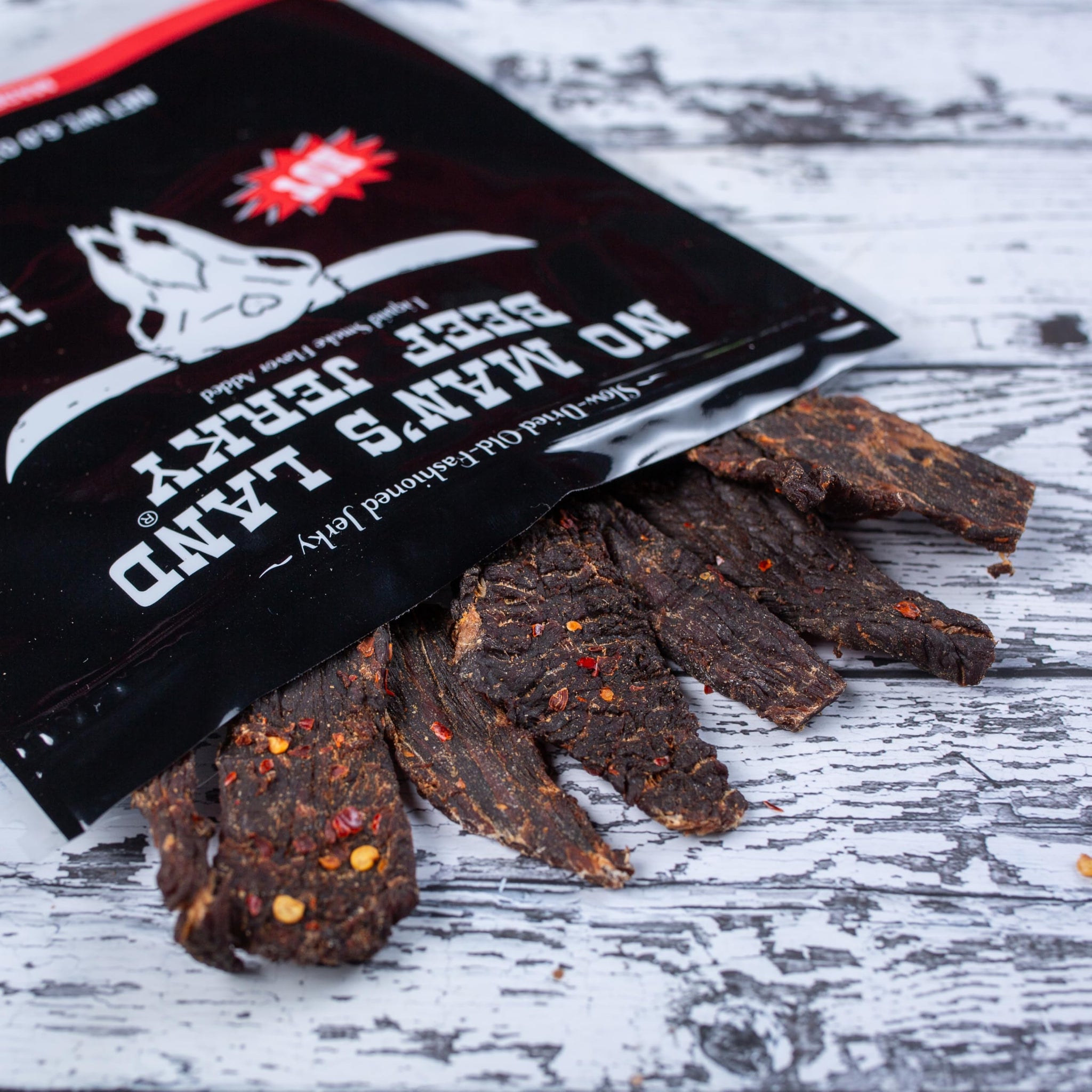 No Mans Land Slow-Dried Beef Jerky | 17G Protein, Low Carb, Low Calorie Beef Snack | Smoked & Seasoned Jerky Strips | HOT 6oz Bag
