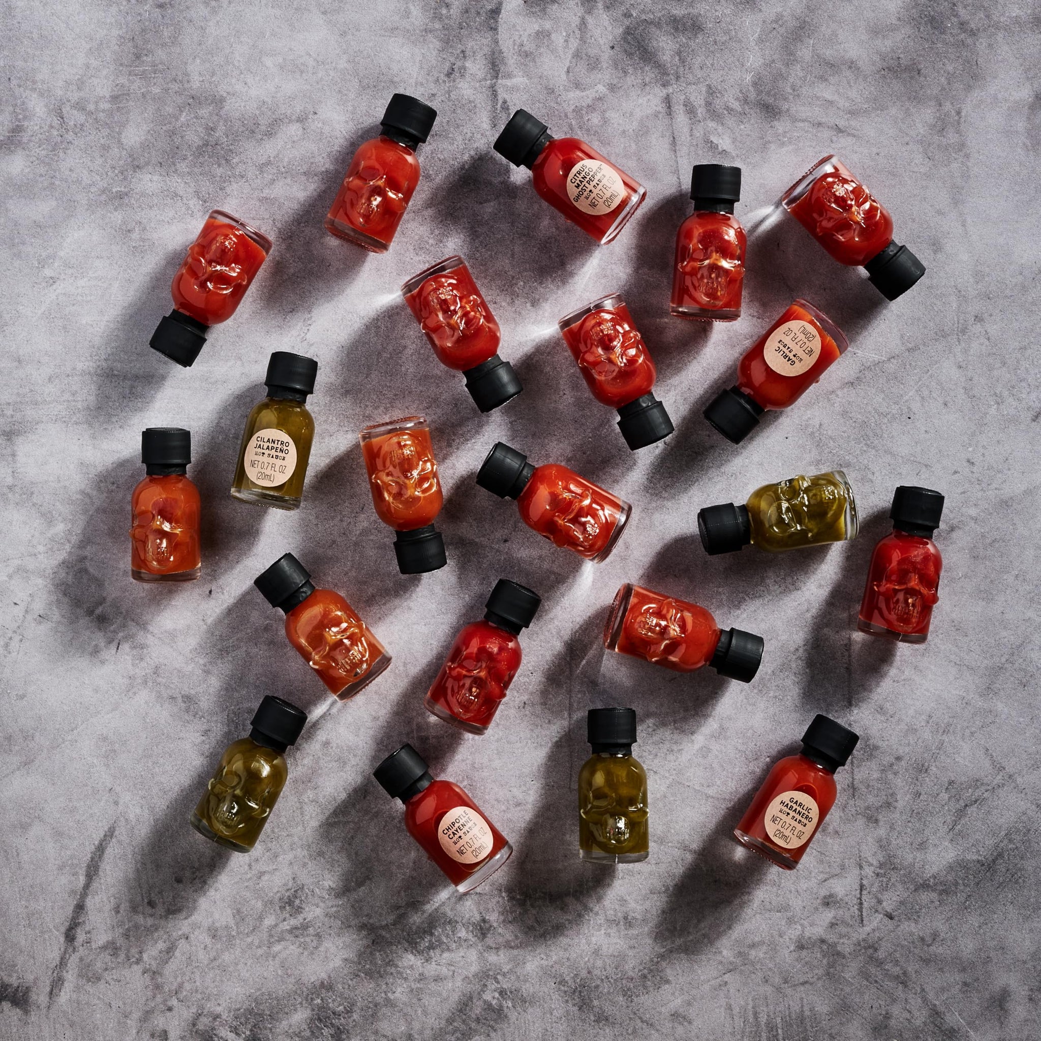 Man Crates, Hot Sauce Inferno Flight, Includes 21 Flavors in Skull-Shaped Mini Hot Sauce Bottles, Spicy Challenge with Habanero, Ghost Pepper & More