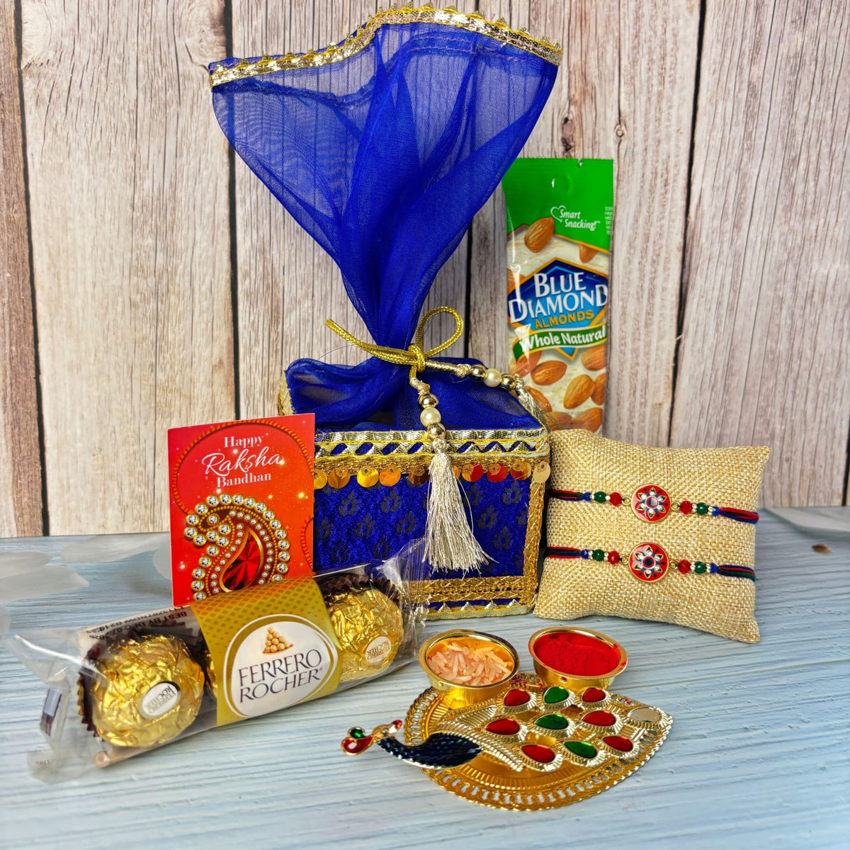 LOVENSPIRE Designer Rakhi Gift Hamper Set for Brother & Bhabhi - Includes 2 Rakhi Bracelet, Haldi Kumkum Holder, Chocolates, Roli Chawal & Gift Box